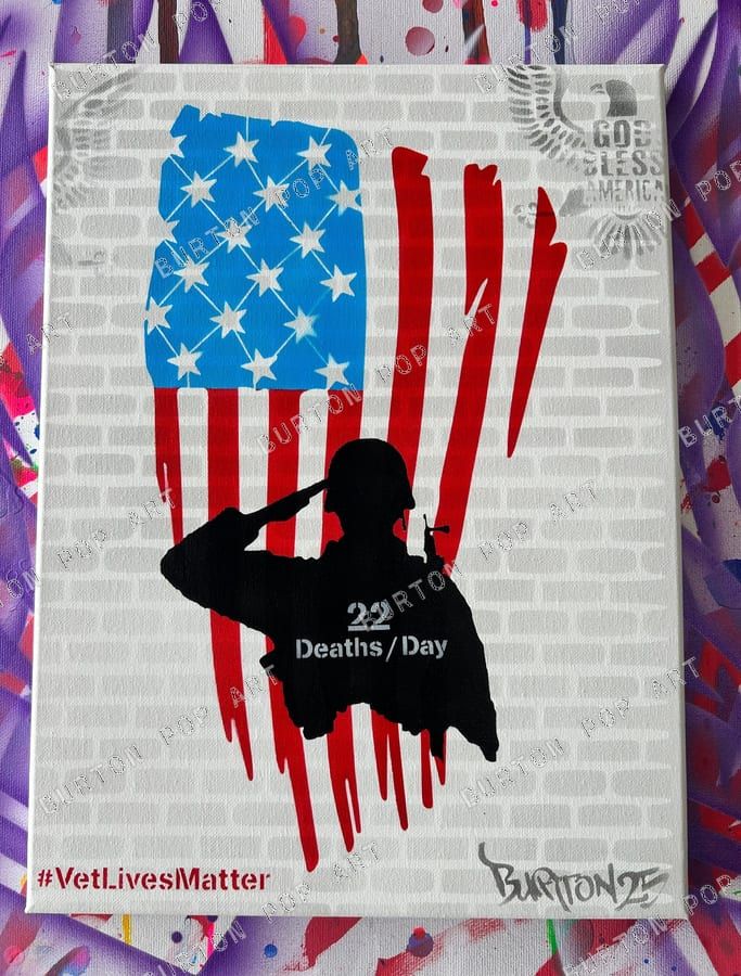 Stencil of a saluting service member over an American flag on brick, captioned 22 Deaths a Day, with #VetLivesMatter.